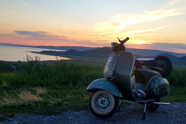 Patinás Vespa a Balaton fölötti dombon, naplementében